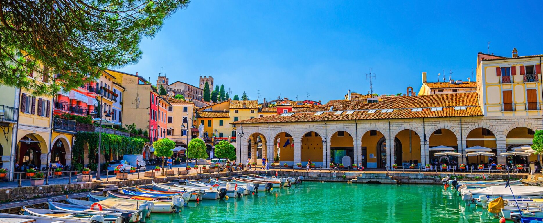 View of Porto-Vecchio harbor in Corsica, with boats moored along the Mediterranean waterfront.