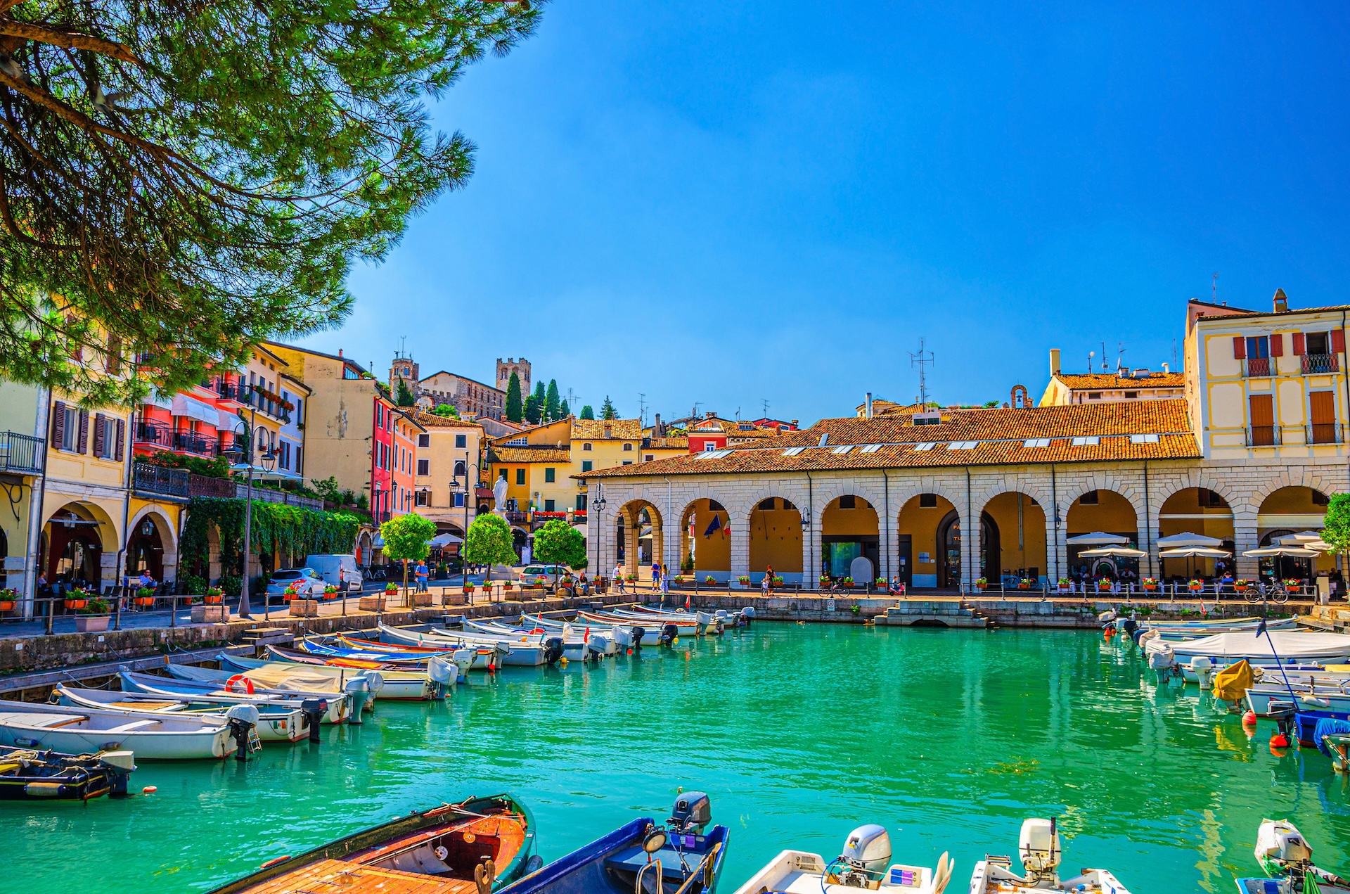 View of Porto-Vecchio harbor in Corsica, with boats moored along the Mediterranean waterfront.